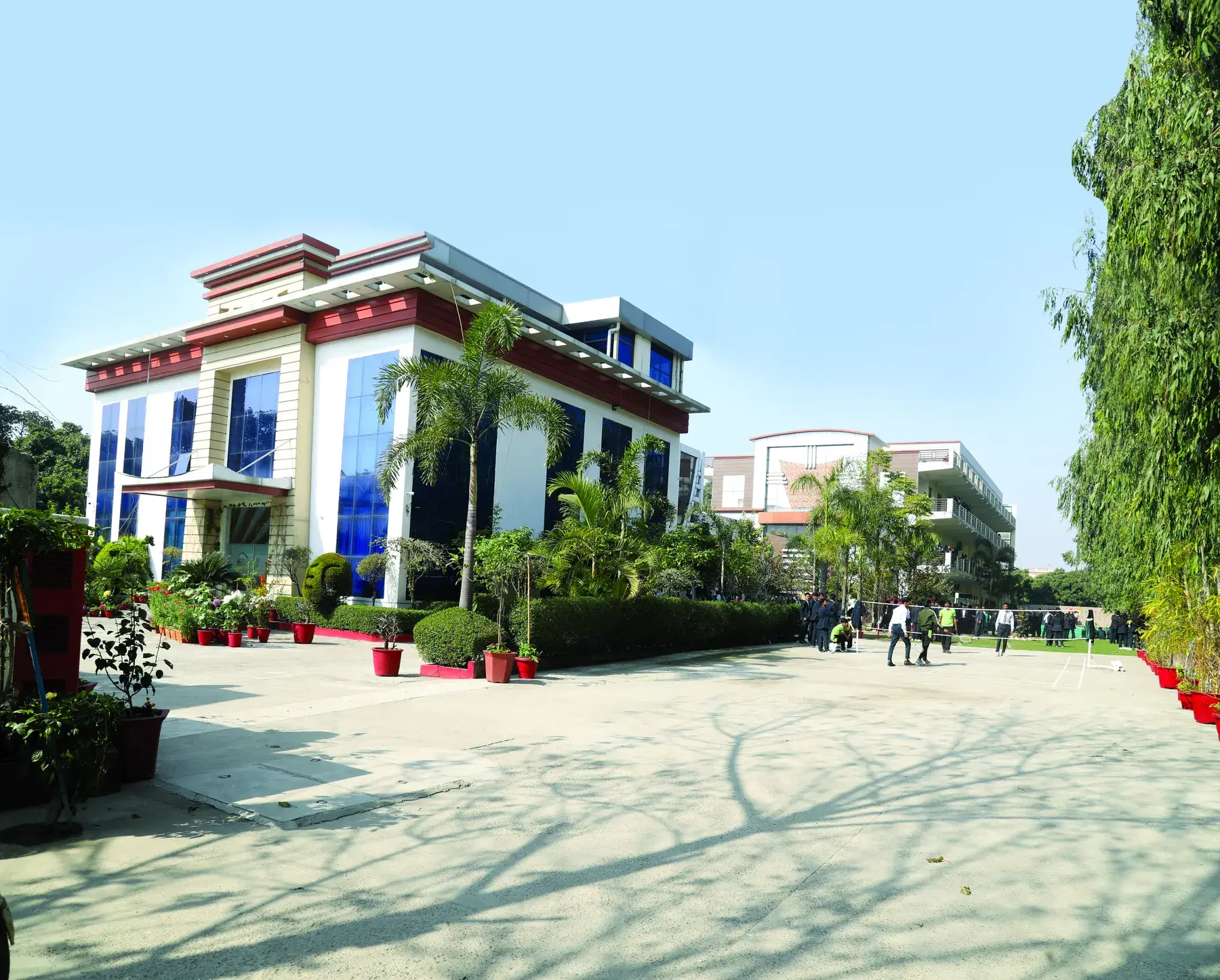 The HEC campus building with landscaped gardens and a wide courtyard