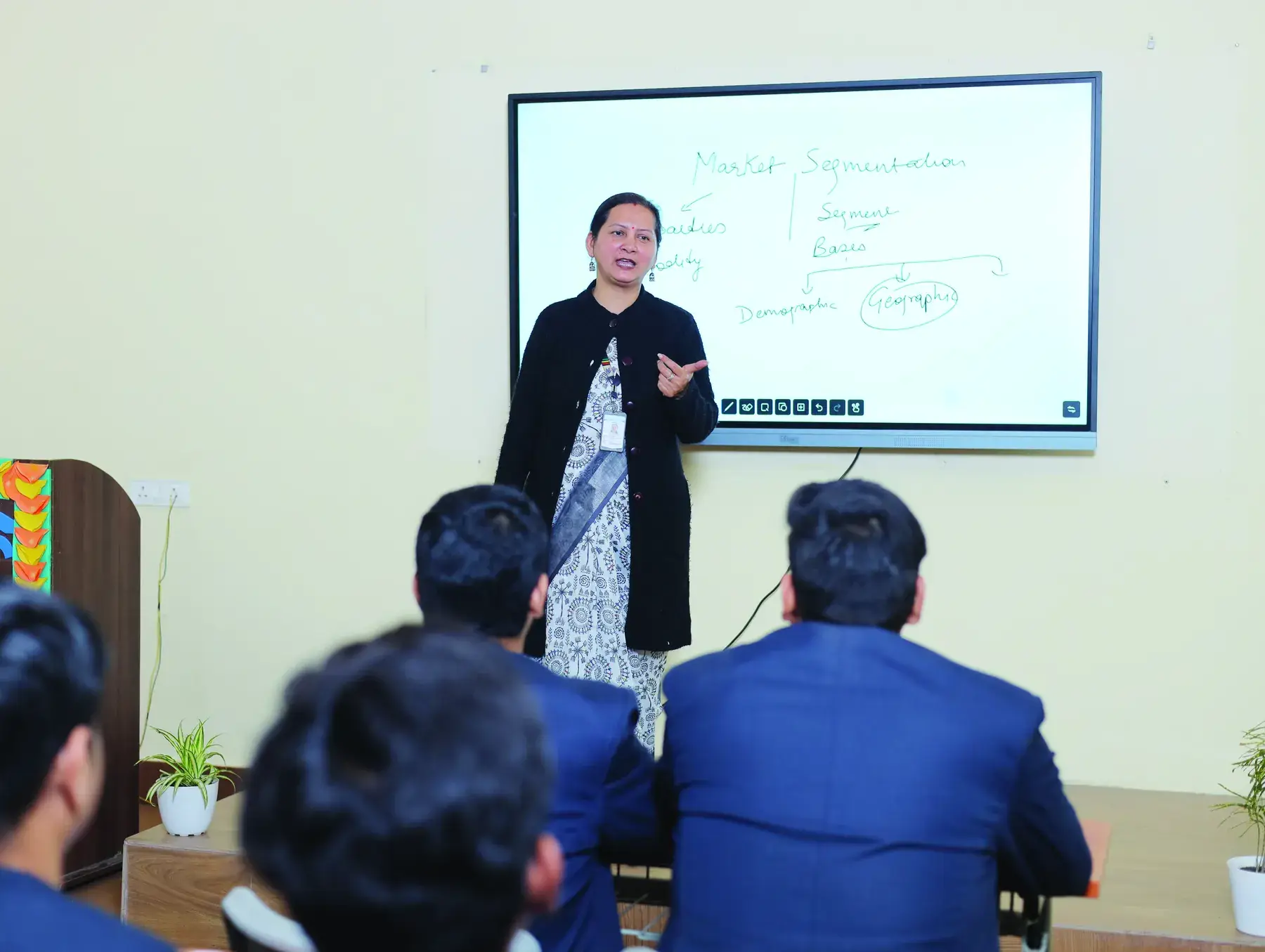 A faculty member teaching at an interactive smart board