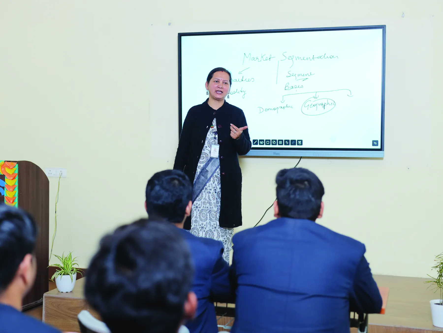 A faculty member teaching at an interactive smart board