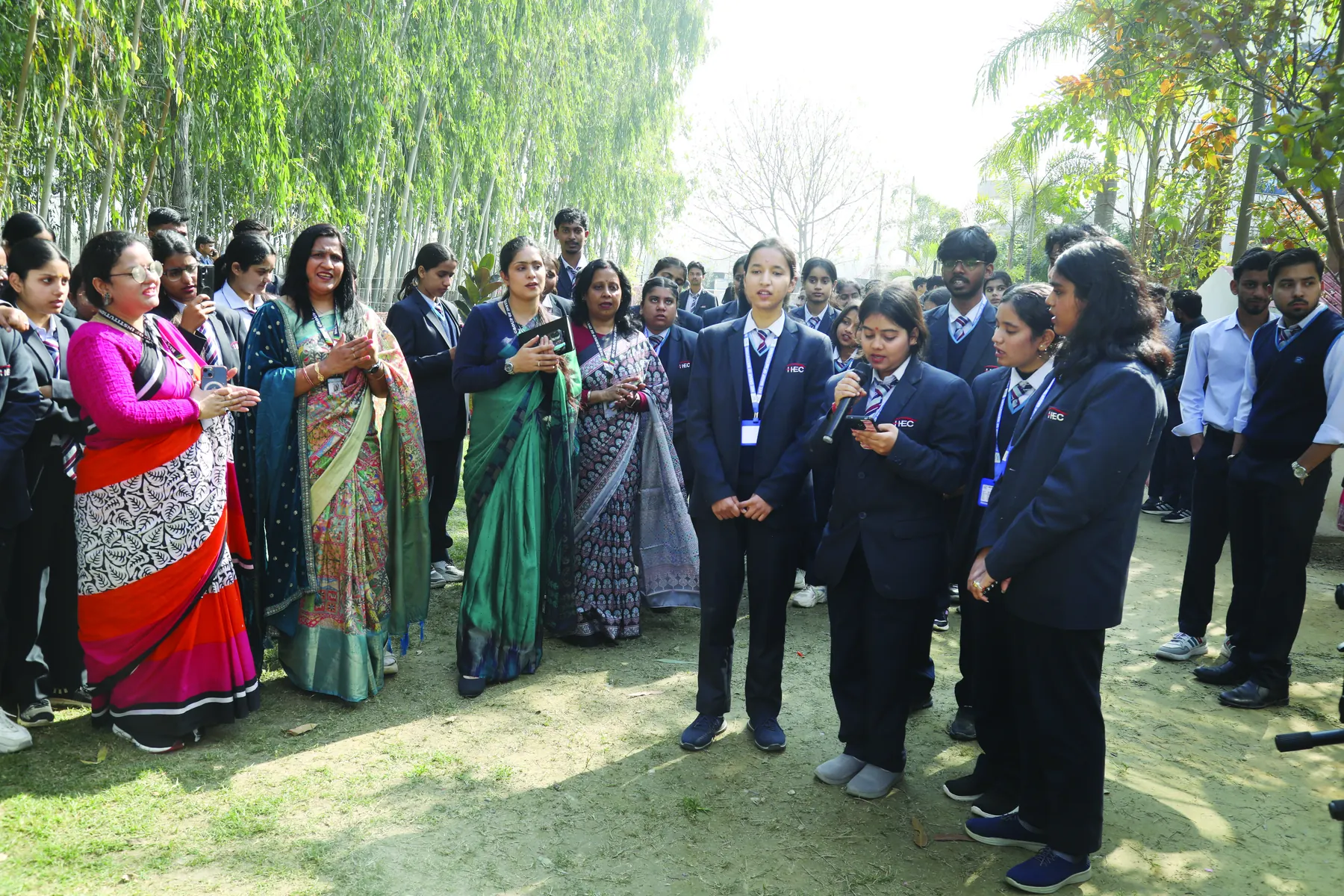 Faculty and students at an outdoor music programme on campus